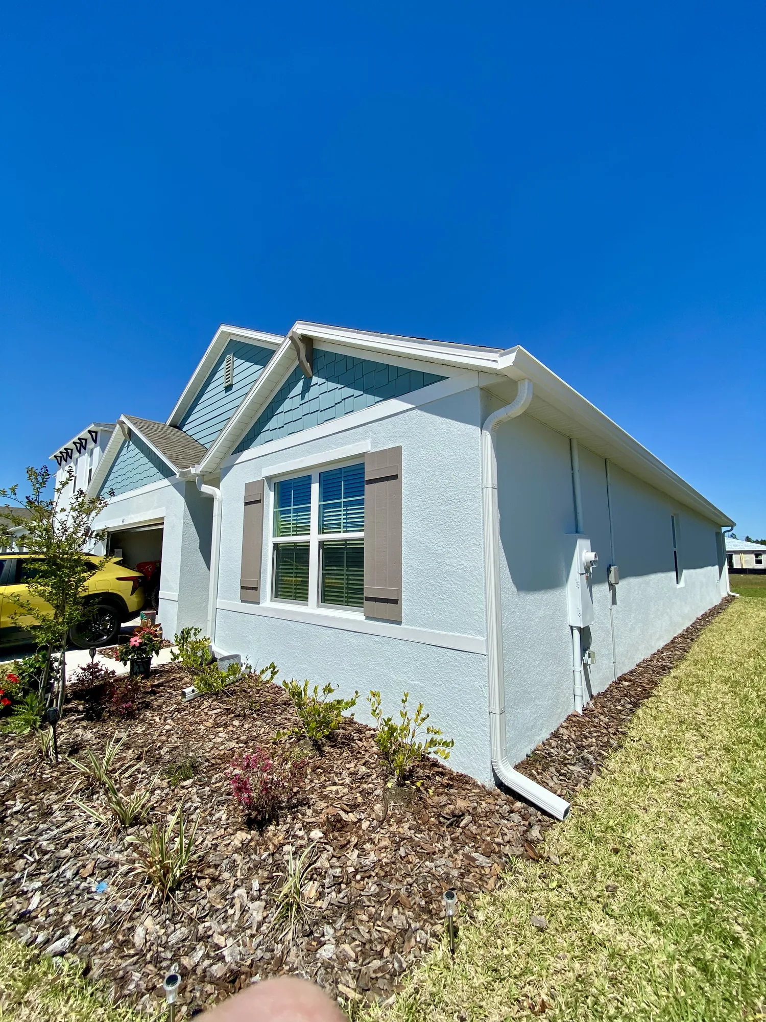 White gutter installed beneath a residential roof edge
