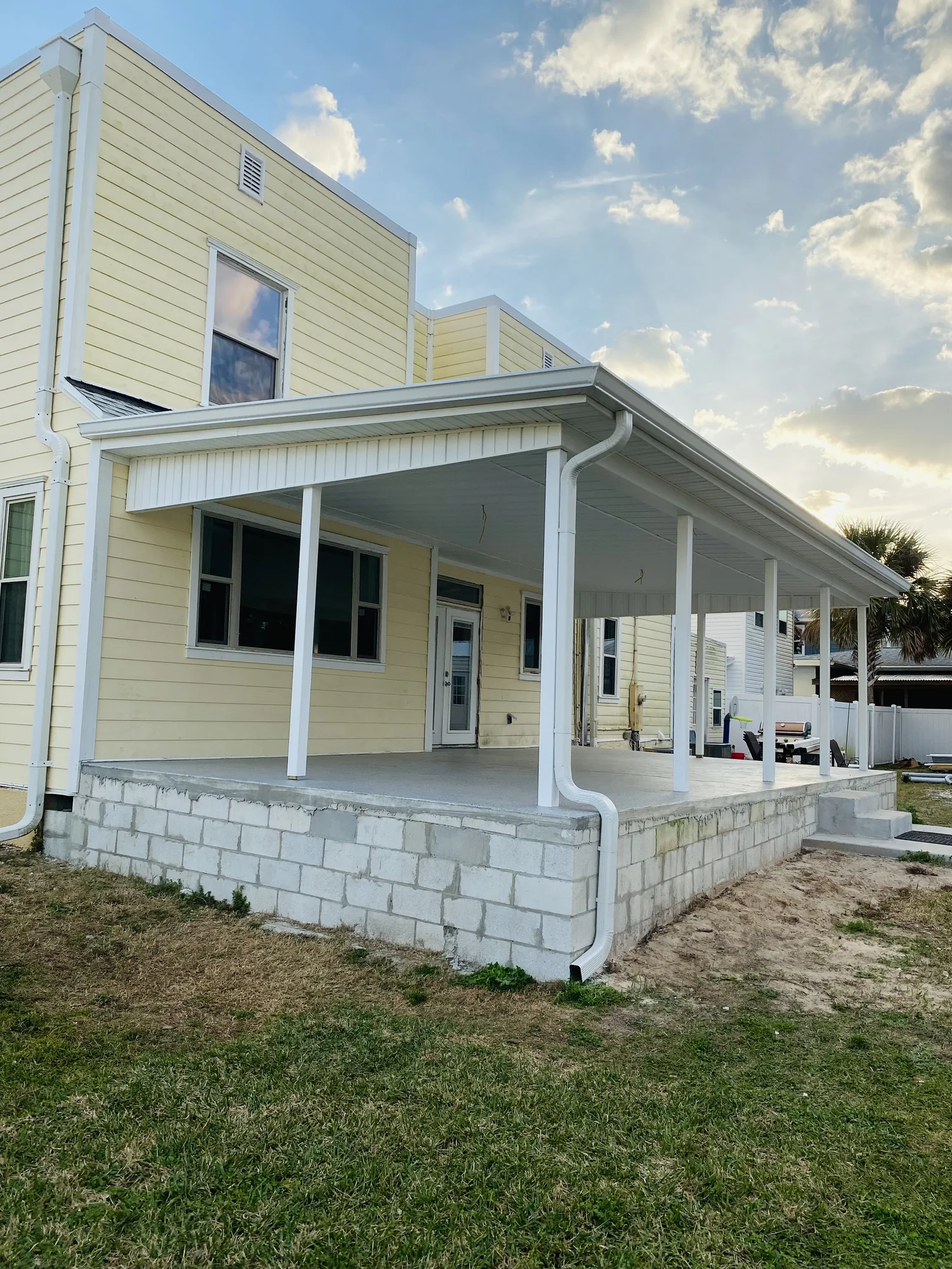 White gutter, soffit and fascia installed on a covered patio